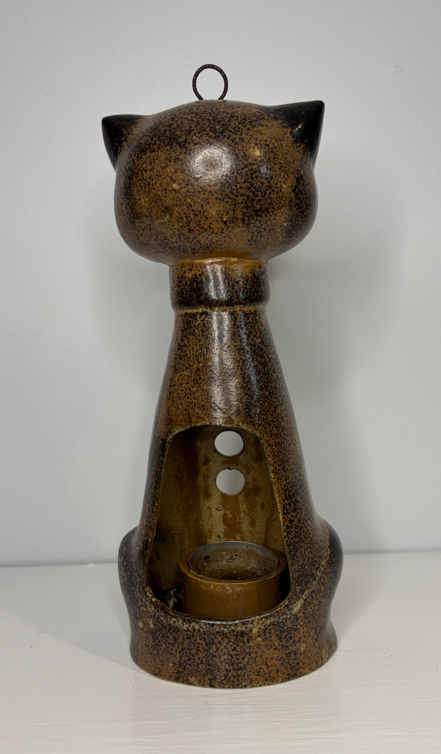 Ceramic cat-shaped lantern with textured brown finish on a white background