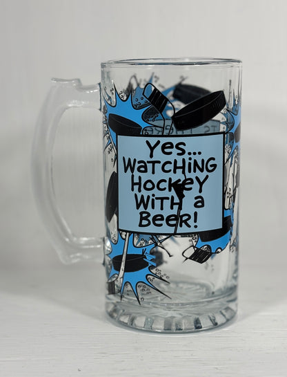 Clear glass mug with hockey-themed design and text on a white background