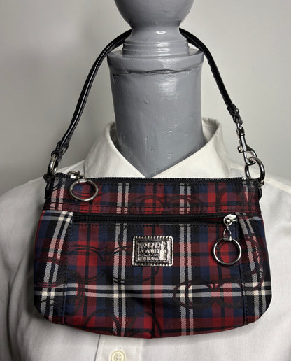 Plaid handbag on a mannequin with a plain background