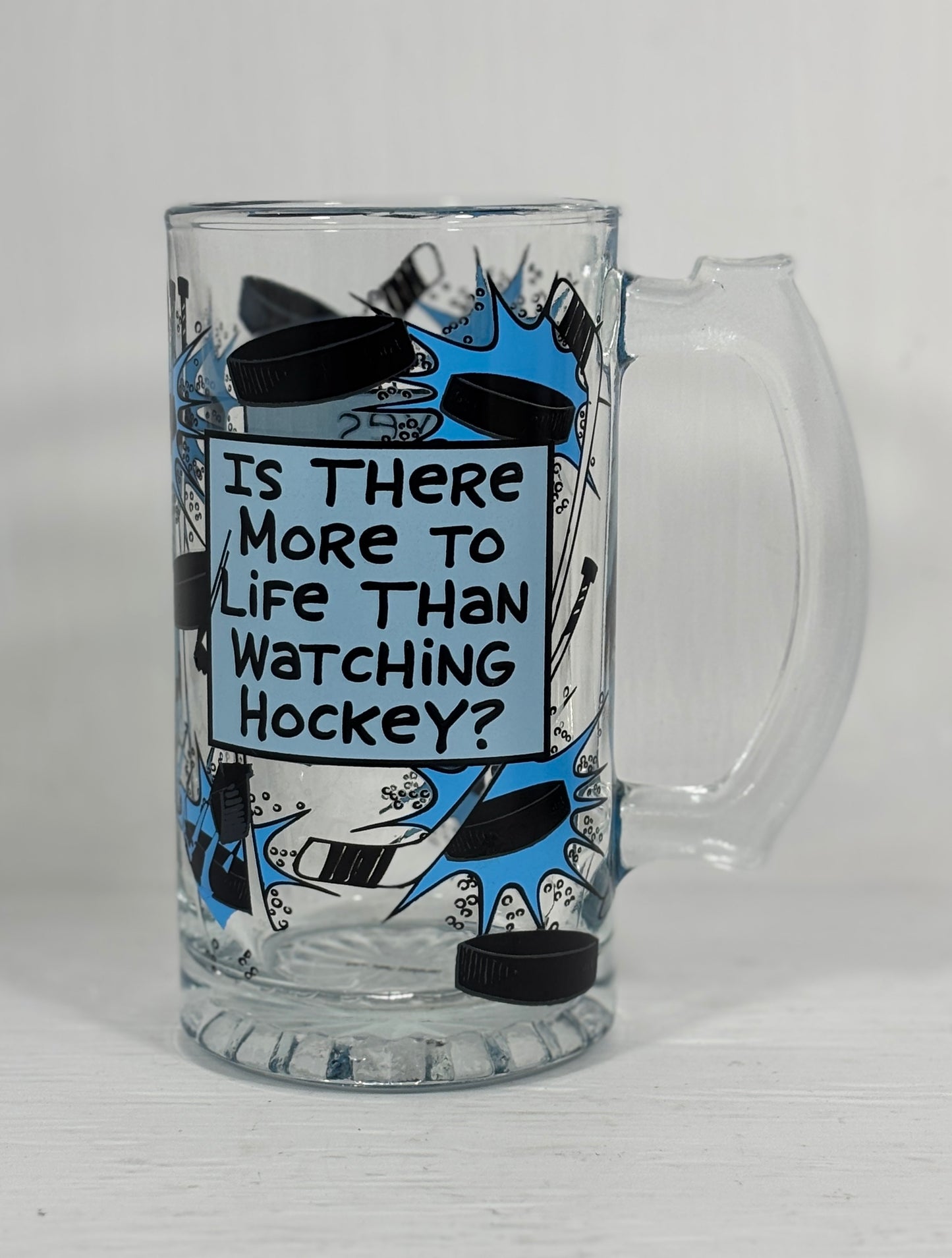 Glass mug with hockey-themed design and text on a white background