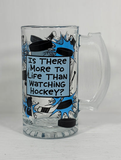 Glass mug with hockey-themed design and text on a white background