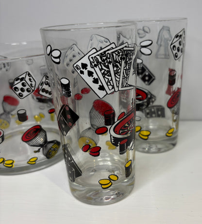 Two glass tumblers with poker-themed designs on a white background