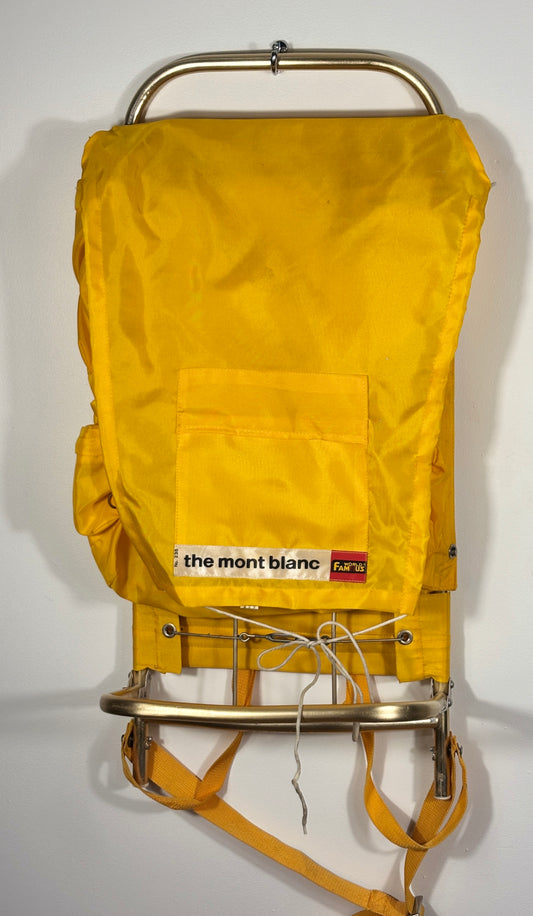 Yellow backpack with metal frame and 'The Mont Blanc' logo on a white background