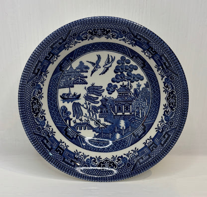 Blue and white decorative plate with intricate patterns on a white background