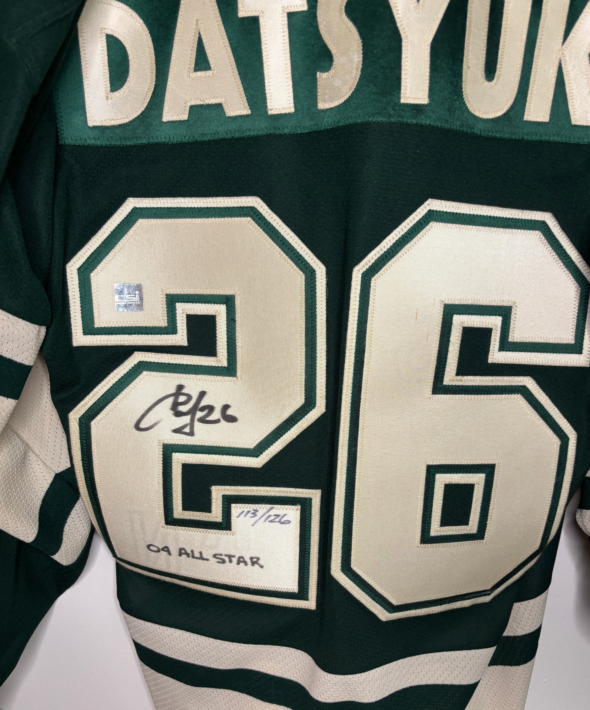 Green sports jersey with number 26 and name 'Datsuyuk' on a white background