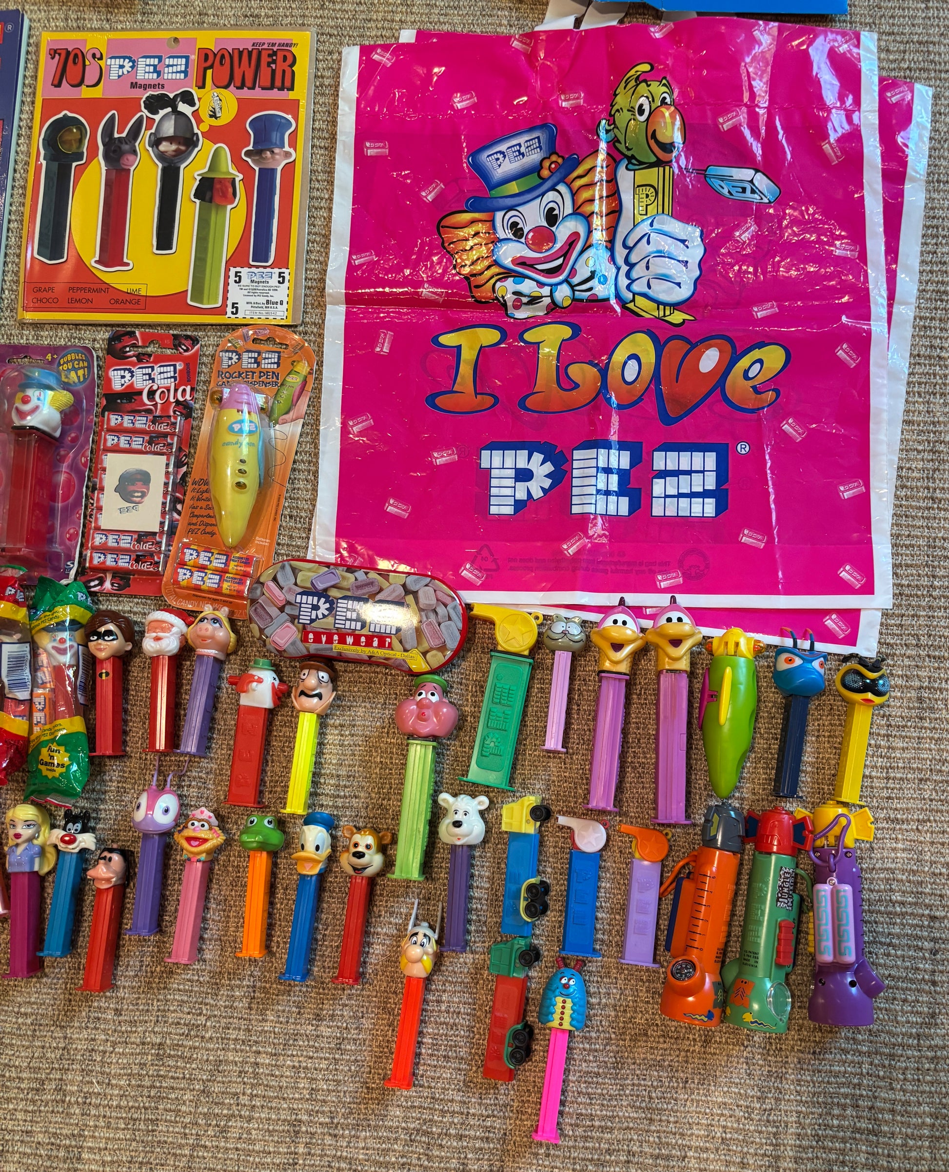 Collection of Pez dispensers and packaging on a textured surface
