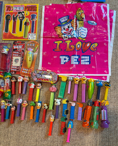 Collection of Pez dispensers and packaging on a textured surface