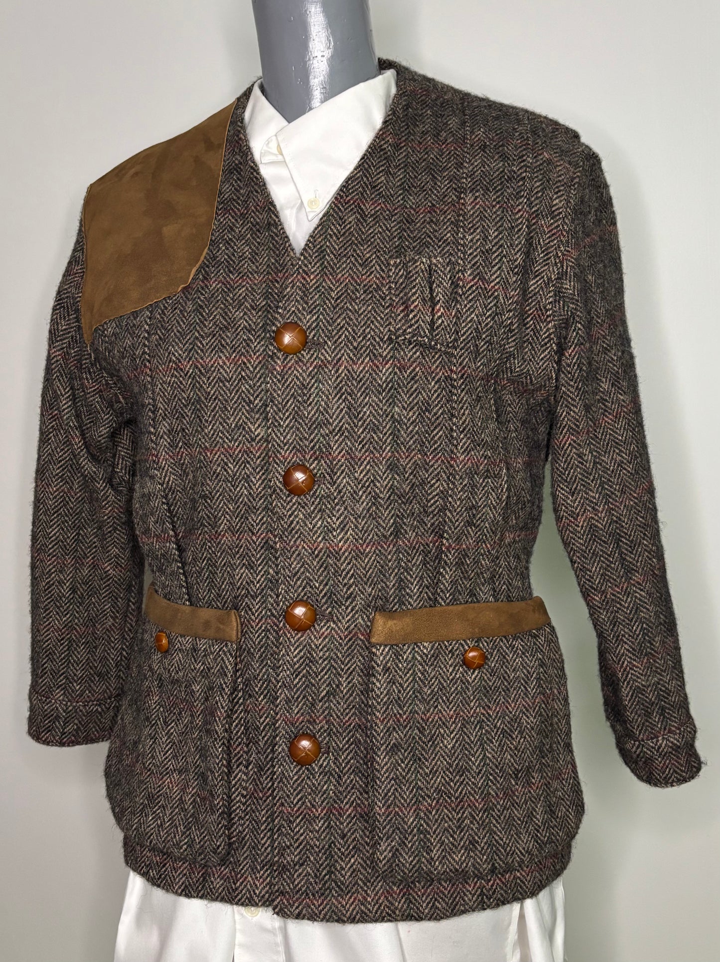 Brown tweed jacket with brown buttons on a mannequin against a white background