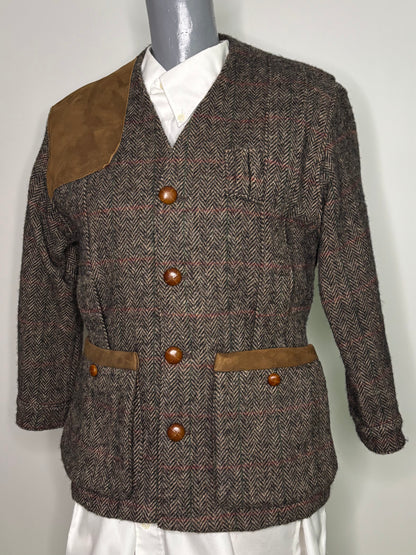 Brown tweed jacket with brown buttons on a mannequin against a white background