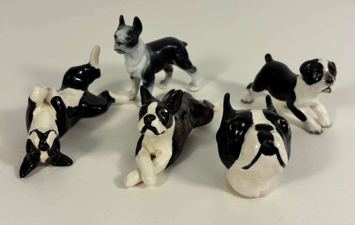 Set of black and white ceramic dog figurines on a light gray background
