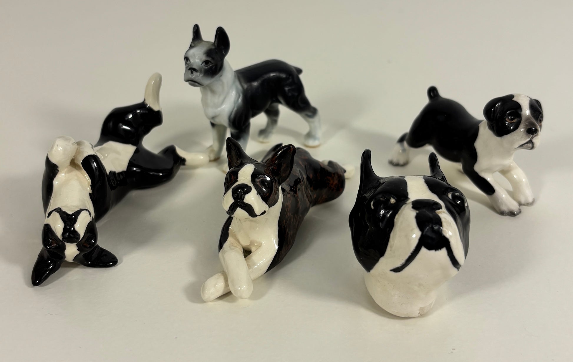 Set of black and white ceramic dog figurines on a light gray background