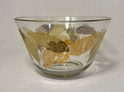Clear glass bowl with gold floral patterns on a white background