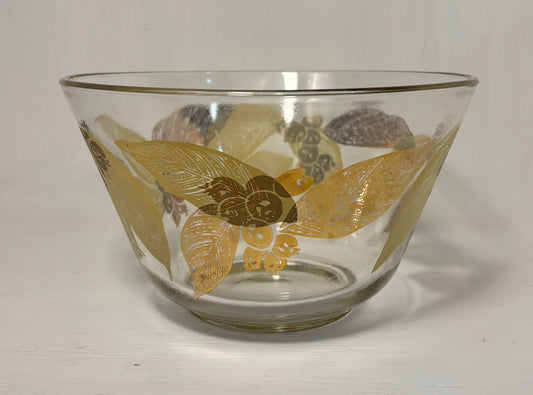 Clear glass bowl with gold floral patterns on a white background