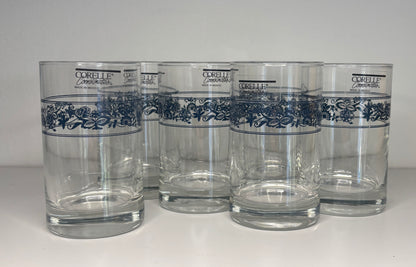 Set of five Corelle glasses with blue floral patterns on a white background