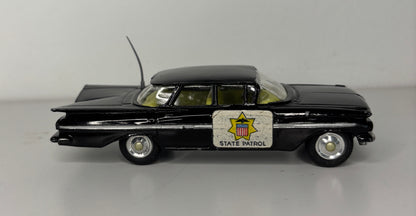 Model of a black police car with 'State Patrol' sign on a gray background