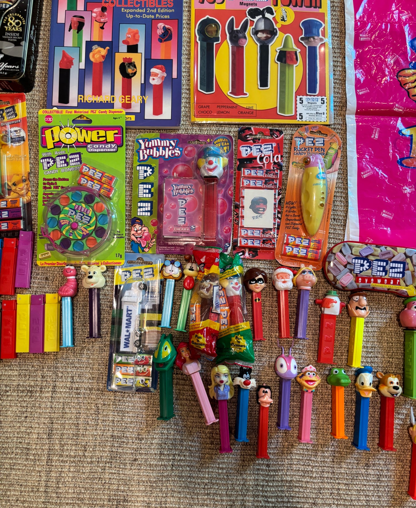Collection of vintage Pez dispensers and packaging on a textured surface