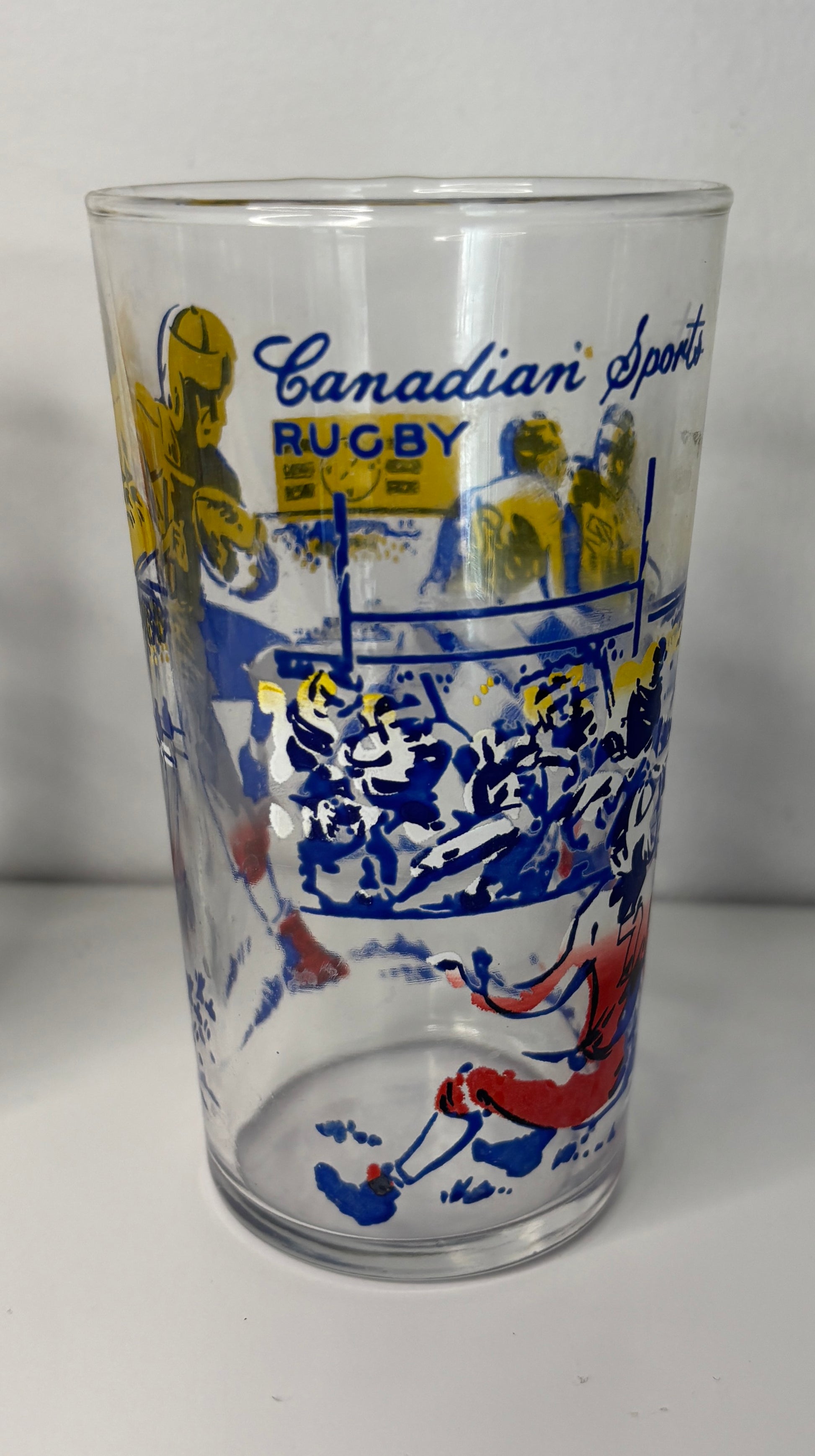Glass tumbler with rugby-themed design and 'Canadian Sports Rugby' text on a white background