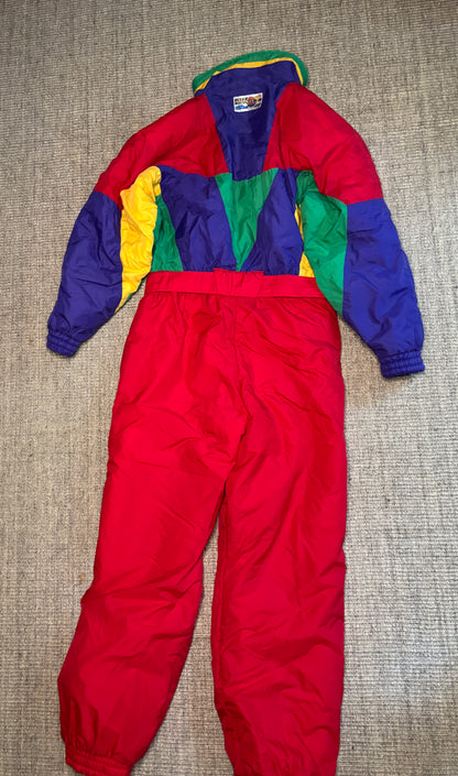 Colorful snowsuit with red base on a textured surface