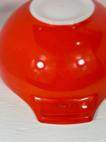 Red bowl with a white interior on a light gray background