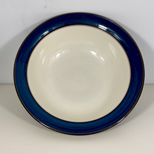 Ceramic bowl with blue rim on a white background