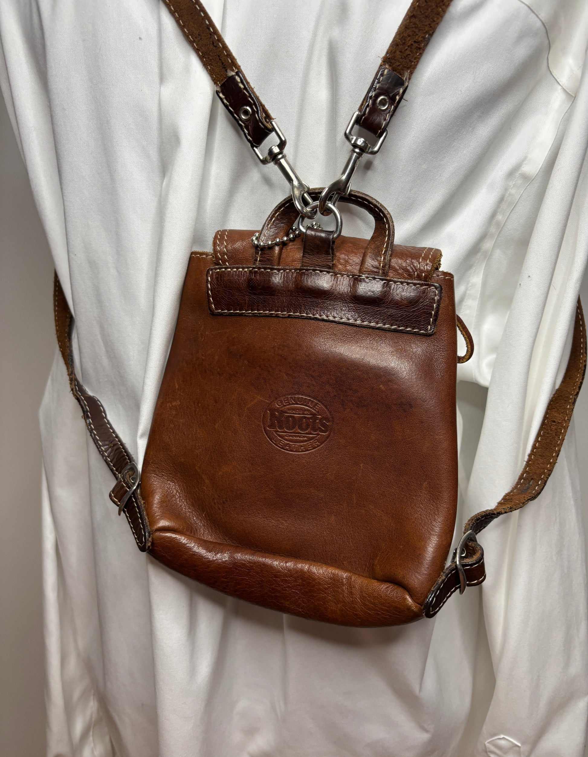 Brown leather bag with visible brand logo on a white background