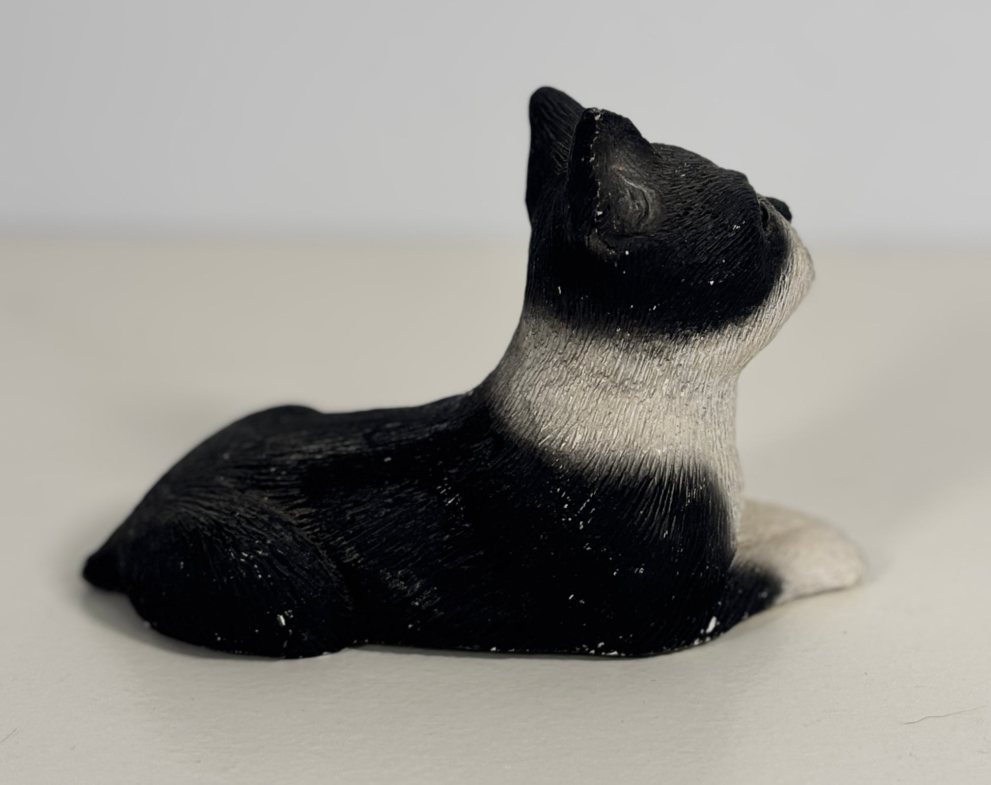 Black and white seal figurine on a light gray background