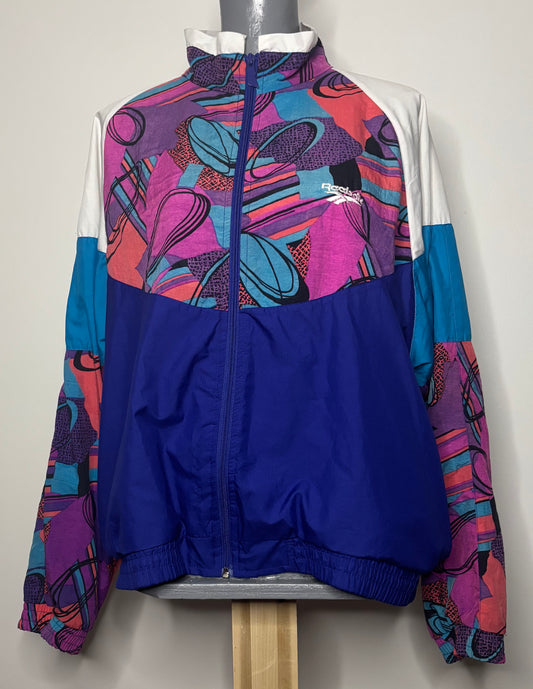 Colorful jacket with abstract patterns on a mannequin against a white background
