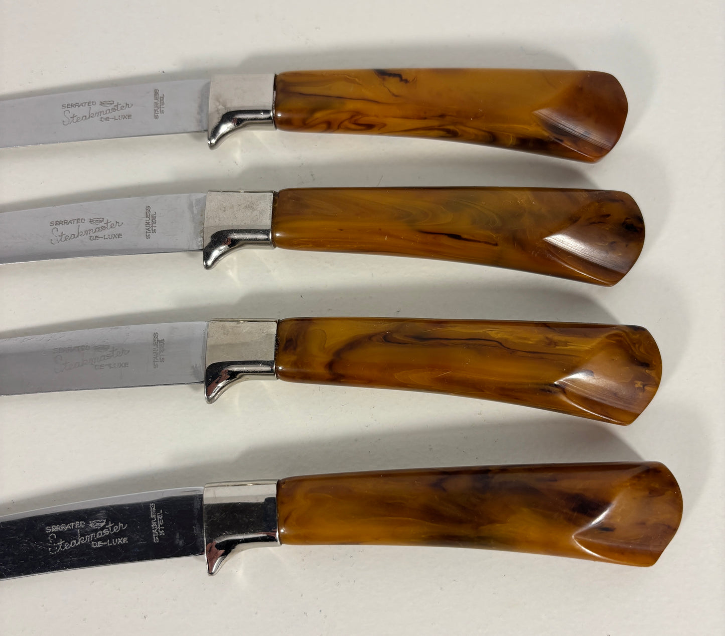 Four knives with wooden handles on a white background