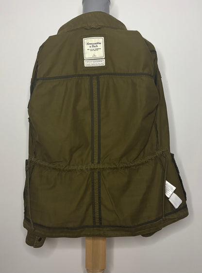 Green jacket on a mannequin with a visible brand label against a white background