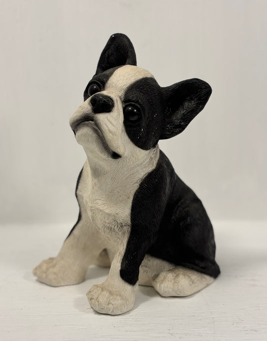 Black and white dog figurine on a white background