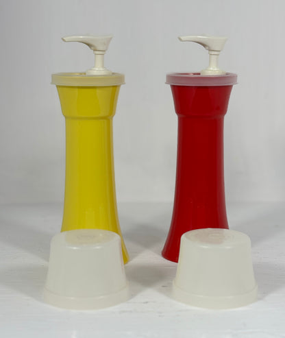 Two plastic condiment dispensers, one yellow and one red, on a white background.