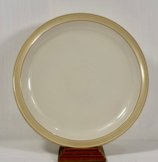 Round beige object on a stand against a white background