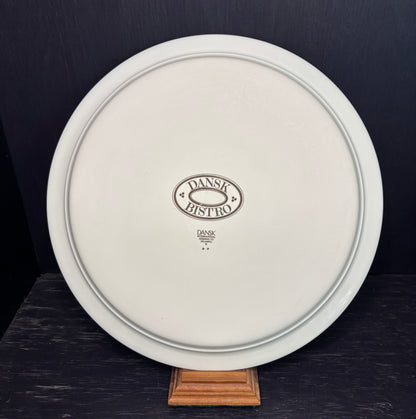 White plate with 'Dansk Bistro' logo on a dark background