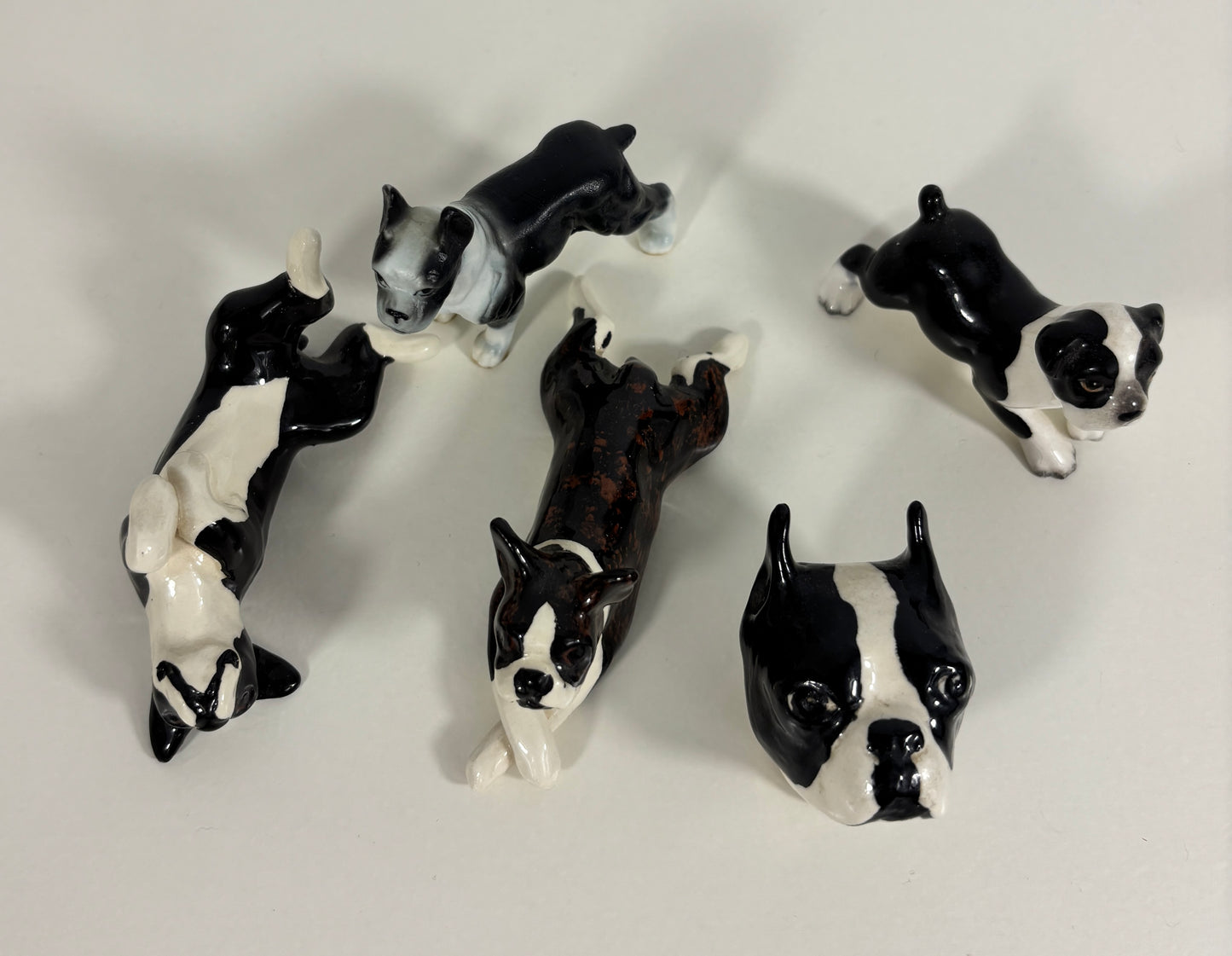 Set of black and white dog figurines on a light gray background