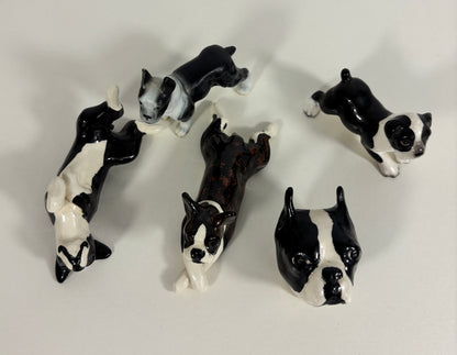Set of black and white dog figurines on a light gray background