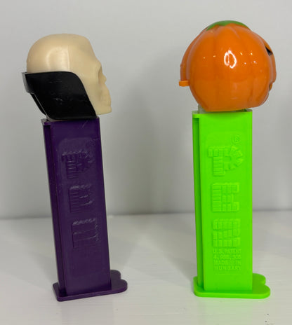 Two novelty items on stands, one purple and one green, with a white background.