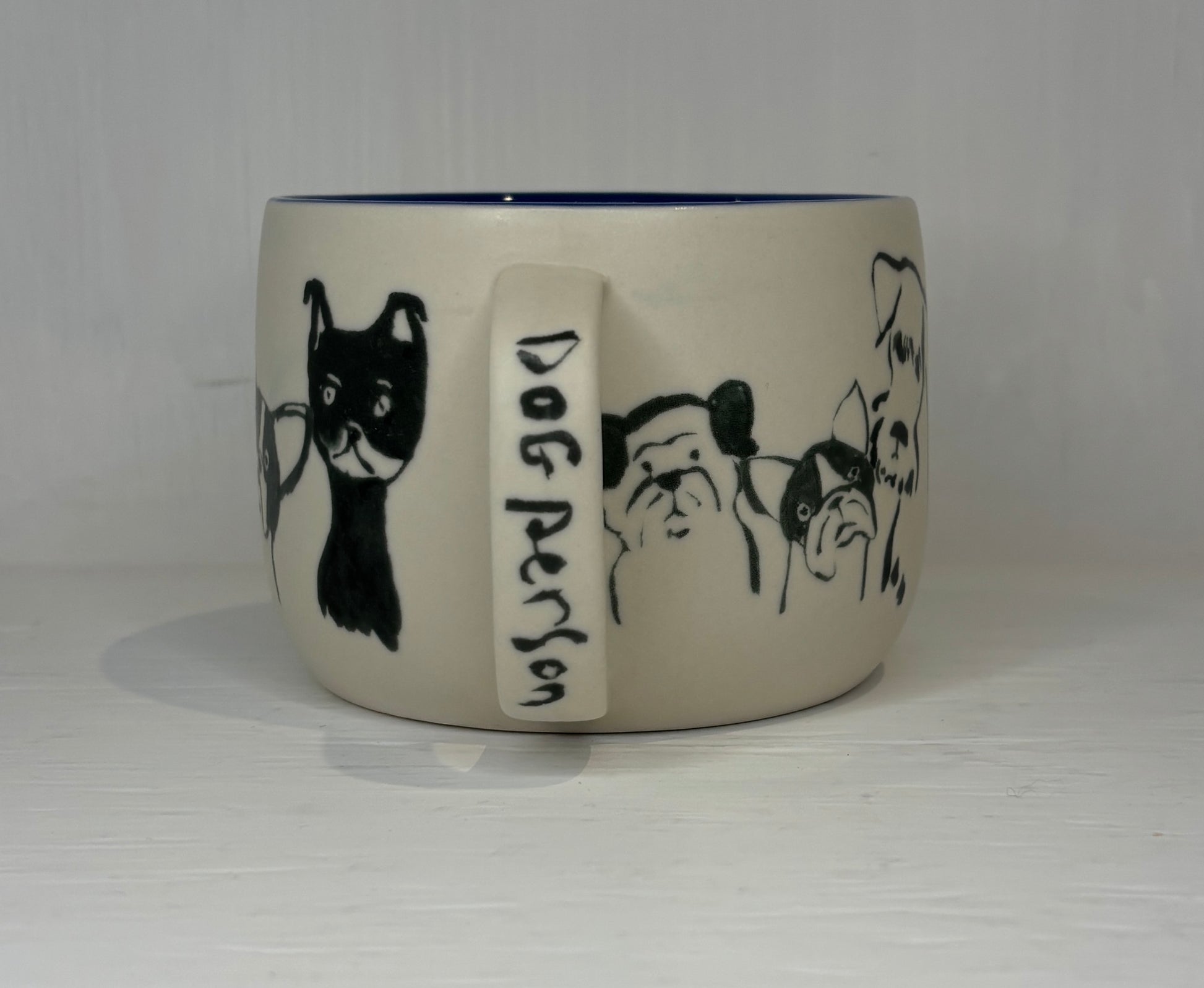 Ceramic mug with dog illustrations and 'Dog Person' text on a white background