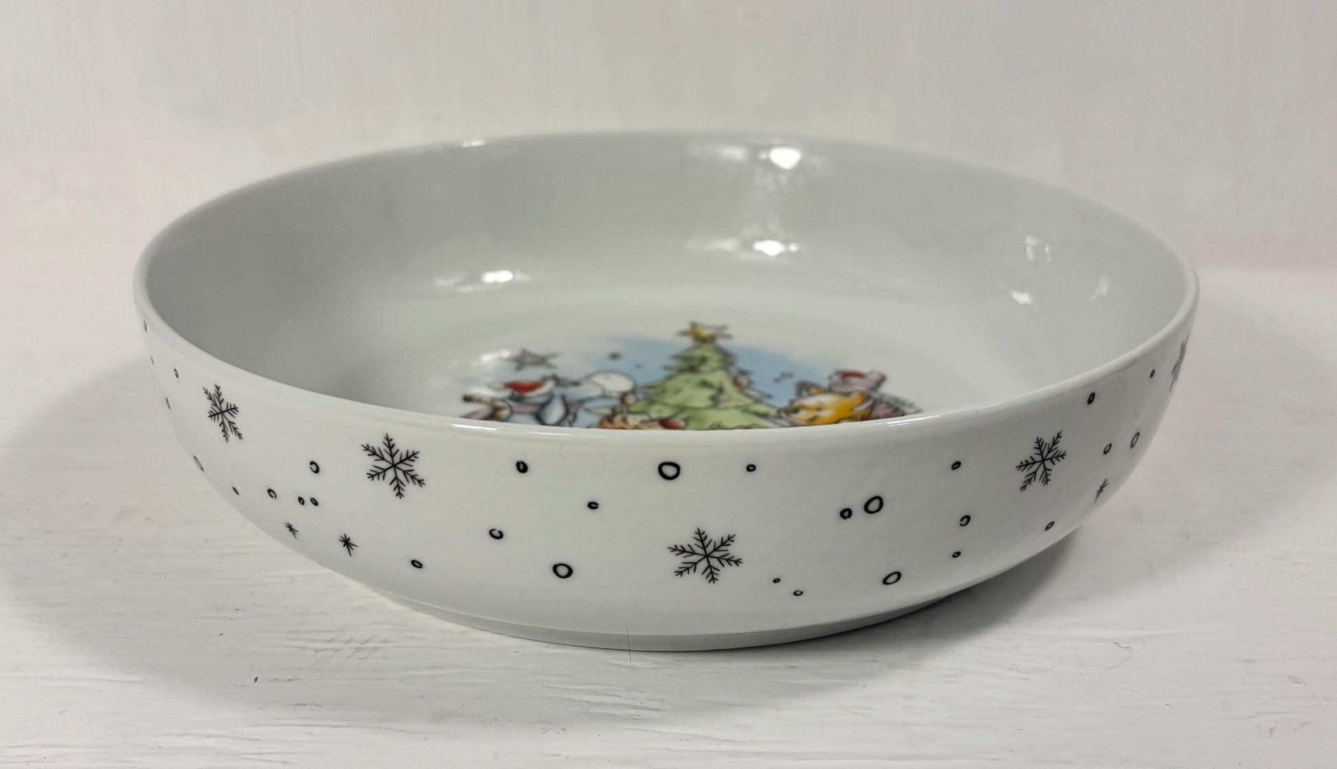 Ceramic bowl with Christmas-themed design on a white background