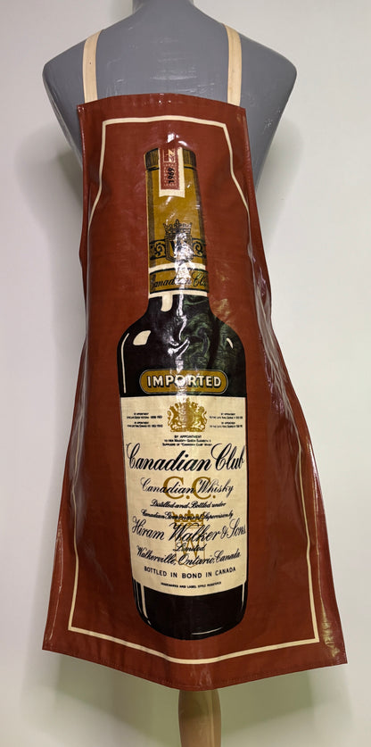 Brown apron with Canadian Club whiskey bottle design on a mannequin.