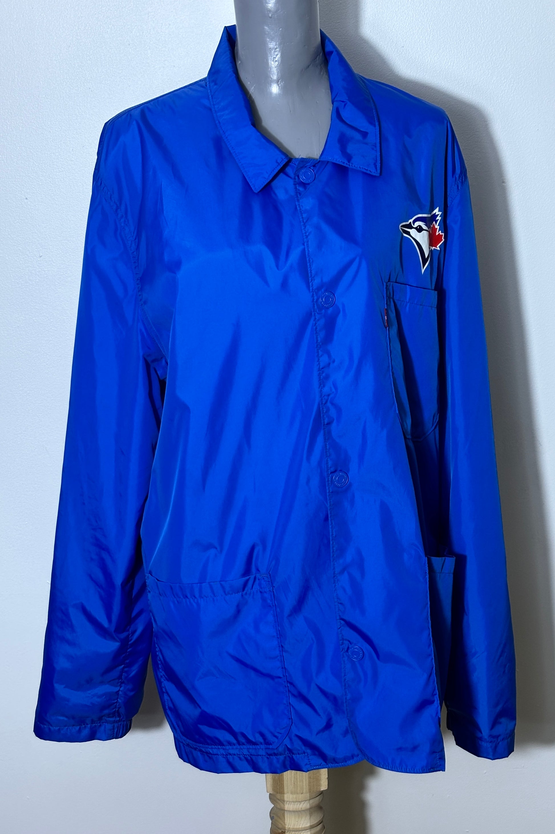 Blue jacket with a logo on a mannequin against a white background