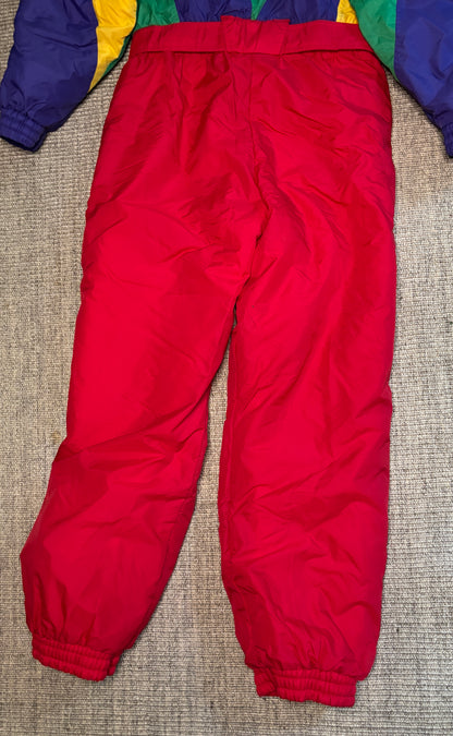Red snow pants on a textured surface