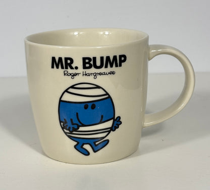 An off-white ceramic mug featuring the 'Mr. Bump' character and text from Roger Hargreaves, set against a plain light background.