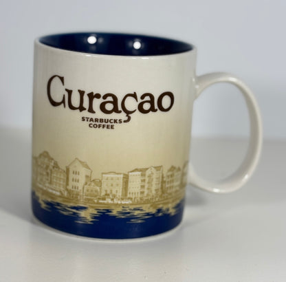 Starbucks Coffee mug with 'Curaçao' text and cityscape design on a white background