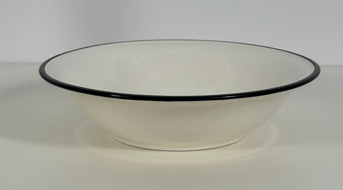 White bowl with black rim on a white background