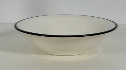 White bowl with black rim on a white background