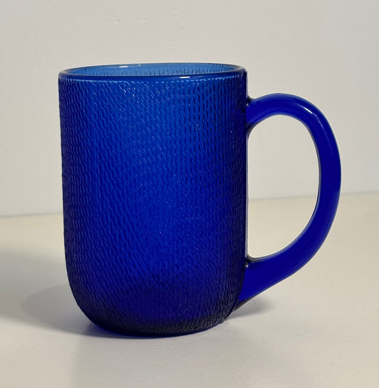 Blue textured mug on a light gray background