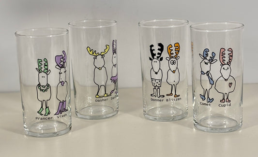 Four glass tumblers with cartoon reindeer designs on a white background