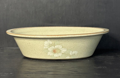 Ceramic bowl with floral design on a dark surface