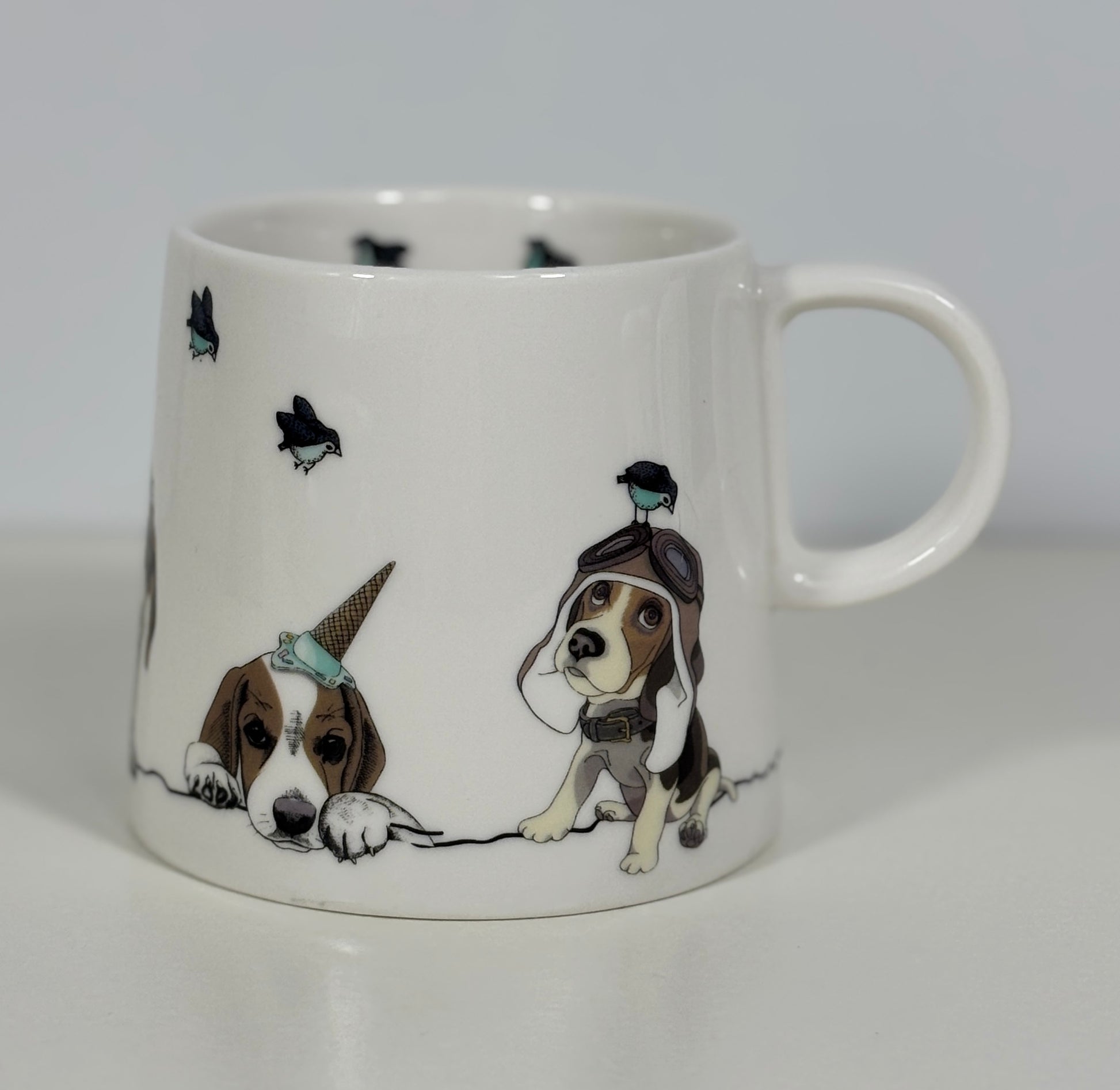 White mug with illustrations of dogs wearing hats and hats on a white background