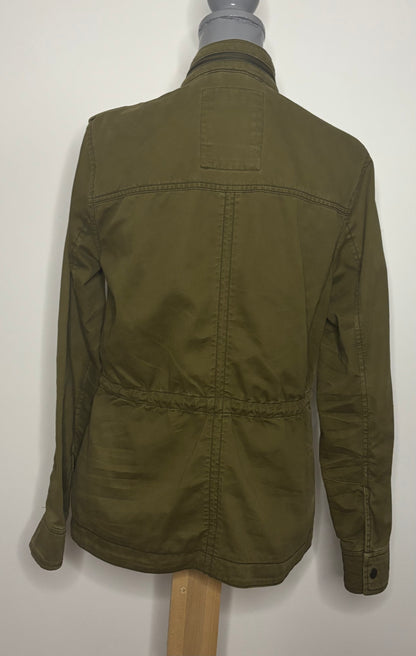 Green jacket on a mannequin against a white background